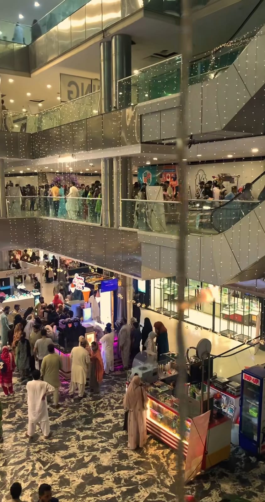 Attendees enjoying Summer Family Fest in a lively indoor venue with vibrant decorations, interactive activities, and a festive ambiance